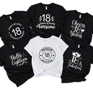 May include: A collection of black and white t-shirts with the number 18 and various phrases. The phrases include "Legally an Adult", "18 years of being Awesome", "Cheers to 18 Years", "Hello Eighteen", "Official 18 Adulthood", and "18 & Fabulous".