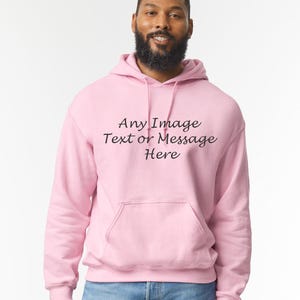 May include: A pink hoodie with a drawstring hood and a kangaroo pocket. The hoodie has the text "Any Image Text or Message Here" printed on the front.