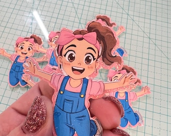 Peut inclure: Un ensemble de quatre découpes en paillettes roses d'une fille de dessin animé portant un nœud rose, une chemise rose, une salopette bleue et des chaussures blanches. La fille saute les bras tendus.
