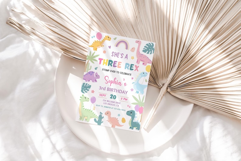 May include: A colourful dinosaur-themed birthday invitation with the text "She's a Three Rex" and "Sophia's 3rd Birthday". The invitation features a rainbow, hearts, and various dinosaurs in shades of pink, blue, green, and yellow.