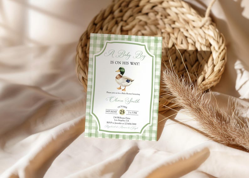 May include: A baby shower invitation with a green gingham border. The invitation features a watercolor illustration of a duck and the text "A Baby Boy Is On His Way!" with event details.