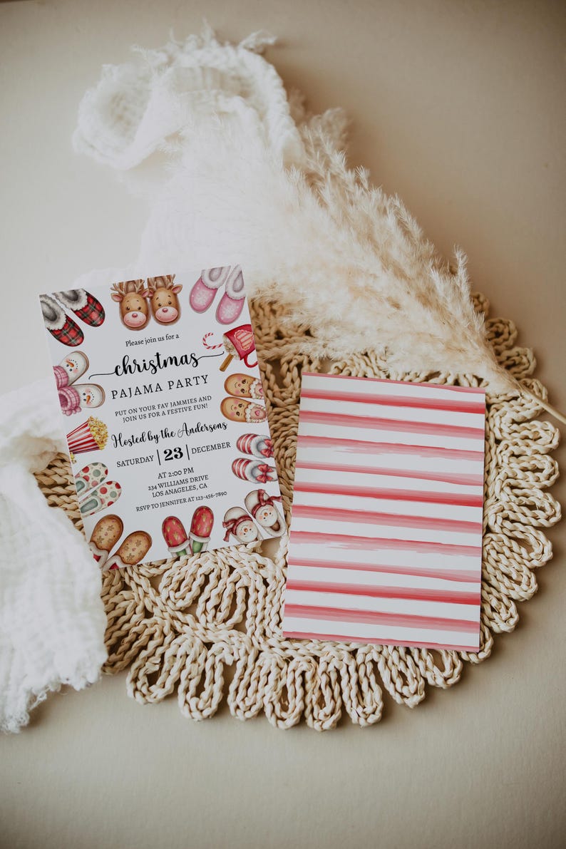 May include: A white Christmas pyjama party invitation with a red and white striped back. The front features a festive illustration of reindeer, slippers, popcorn, and candy canes. The text reads "Please join us for a Christmas Pyjama Party. Put on your fav jammies and join us for a festive fun! Hosted by the Andersons. Saturday | 23 | December. At 2:00 PM. 254 Williams Drive. Los Angeles, CA. RSVP to Jennifer at 415-449-7890."