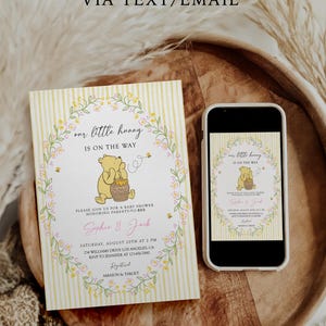 May include: A baby shower invitation featuring a Winnie the Pooh theme. The invitation is a light yellow with vertical stripes and a floral wreath design. The text reads "our little hunny is on the way" and includes event details. A smartphone displays the same design.