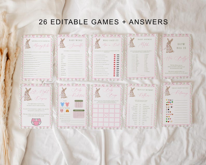 May include: A collection of eight baby shower game cards with a floral and bunny design. The cards have pink and white borders and include game titles like "Baby Word" and "How Big Is Her Stuff?" The text "26 Editable Games + Answers" is at the top.
