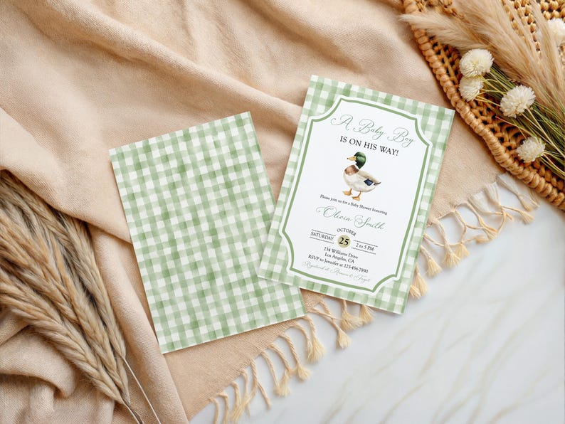 May include: Baby shower invitation with a green and white gingham pattern. The invitation features a watercolor illustration of a duck and the text "A Baby Boy Is On His Way!" The invitation includes event details.