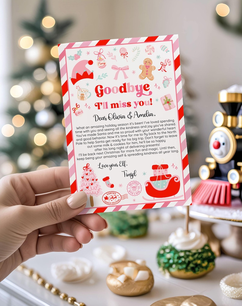 May include: A Christmas-themed card with a red and pink border, held by a hand. The card features festive illustrations and the text "Goodbye, I'll miss you!" along with a personalized message. A toy train is in the background.