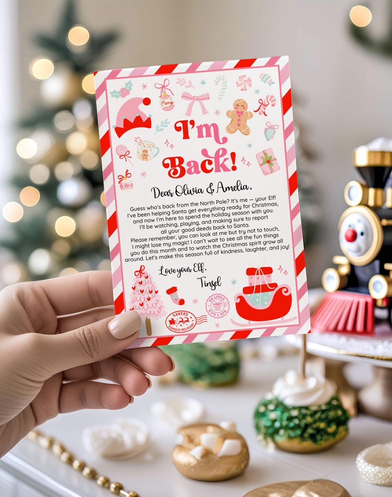 May include: A Christmas-themed card held by a hand, featuring a pink and red striped border. The card has the text "I'm Back!" and a letter to Olivia & Amelia from their Elf, Tinsel, with festive illustrations.
