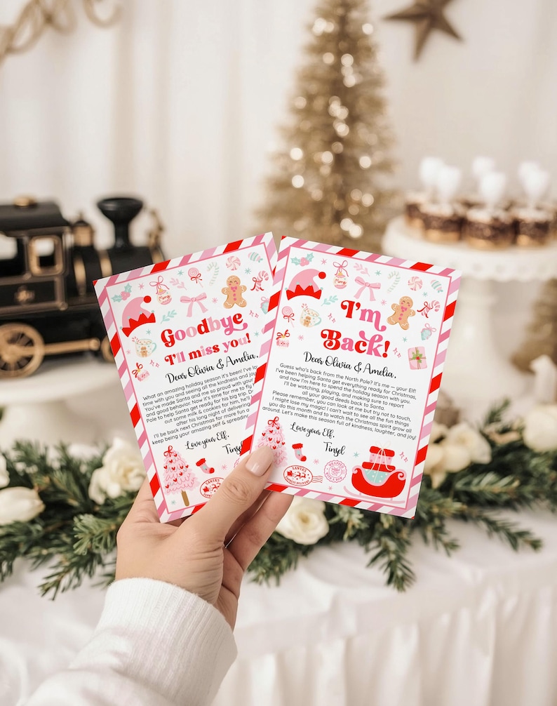 May include: Two Christmas-themed cards with pink and red borders are held in a hand. The cards have festive illustrations of elves, gingerbread men, and Christmas trees. One card reads "Goodbye I'll miss you!" and the other says "I'm Back!"