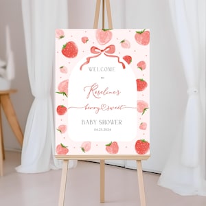 May include: Pink and red baby shower welcome sign with a strawberry theme. The sign says "Welcome to Roseline's Berry Sweet Baby Shower 04.25.2024".