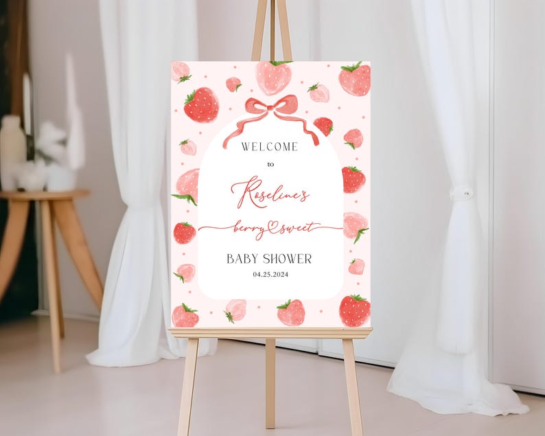 May include: Pink and red baby shower welcome sign with a strawberry theme. The sign says "Welcome to Roseline's Berry Sweet Baby Shower 04.25.2024".