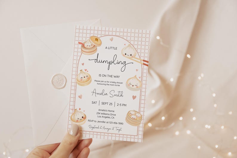 May include: A baby shower invitation card with a dumpling theme. The card features illustrations of dumplings and the text "A Little Dumpling Is On The Way". The card is held with a white envelope and a wax seal.