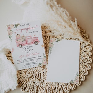 May include: A pink baby shower invitation with a watercolor illustration of a pink truck carrying pumpkins and flowers. The text reads "a sweet little pumpkin is on the way" and includes the details for the baby shower, including the date, time, location, and RSVP information.