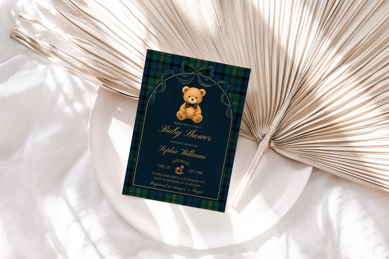 May include: A baby shower invitation with a navy blue background and a plaid border. The invitation features a teddy bear illustration and gold text that reads "Baby Shower" and the name "Sophie Williams".