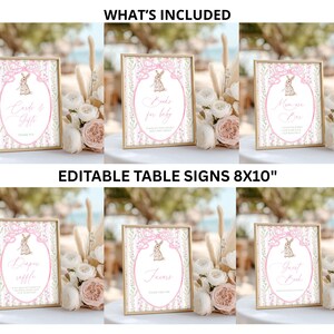 May include: A collection of six framed signs with gold borders, featuring pink and white designs with a bunny illustration. The signs include text such as "Cards & Gifts" and "Favors". The text "WHAT'S INCLUDED" and "EDITABLE TABLE SIGNS 8X10" are also visible.