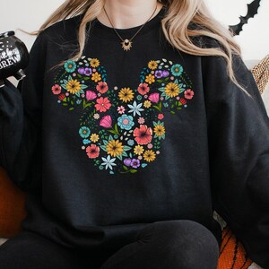 a woman sitting on a couch holding a camera