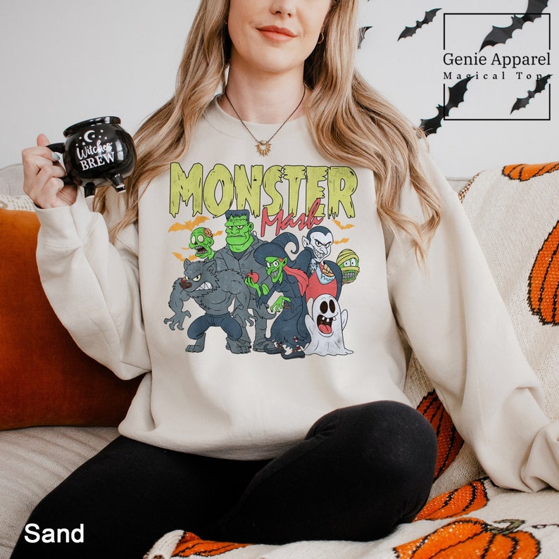 a woman sitting on a couch holding a remote control Monster Mash Halloween Sweatshirt, Monster Mash Halloween Hoodie, Halloween Monsters Sweatshirt, Halloween Party Hoodie