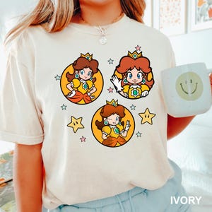 a woman holding a cup and wearing a tshirt