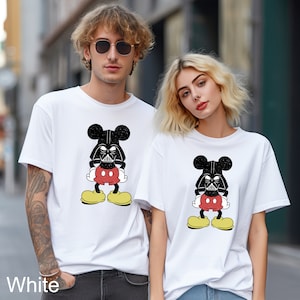 a man and a woman wearing mickey mouse shirts
