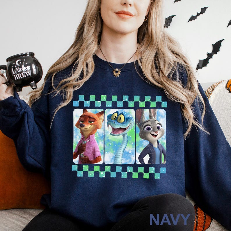 A woman wearing a navy blue sweatshirt with a graphic design featuring cartoon animal characters.