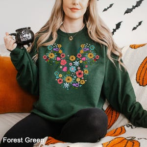 a woman sitting on a couch holding a remote control