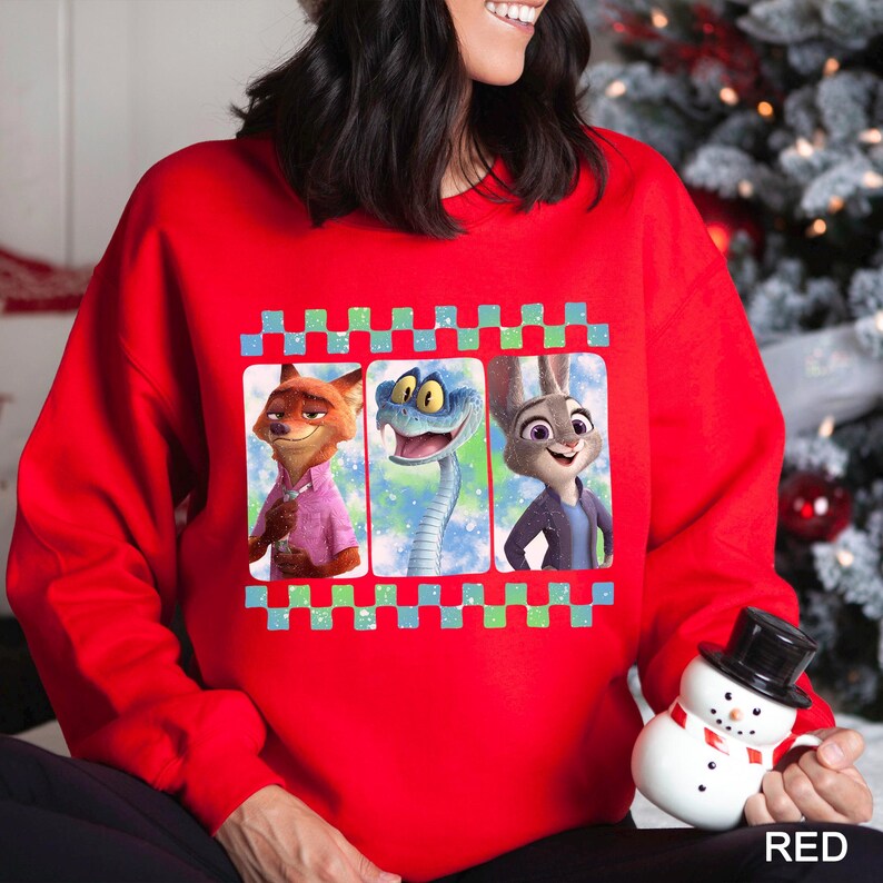 A woman wearing a red sweater with a graphic of three cartoon animal characters, including a fox, a snake, and a rabbit.