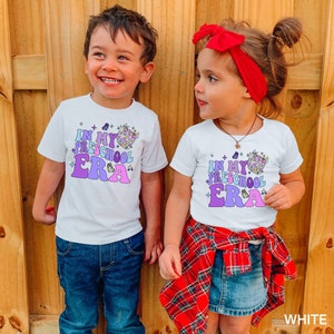 two little girls standing next to each other