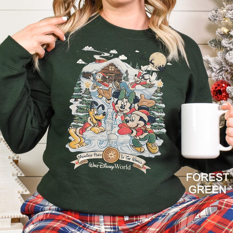 a woman holding a coffee mug in front of a christmas tree