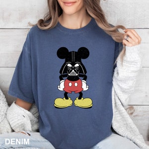 a woman wearing a mickey mouse t - shirt