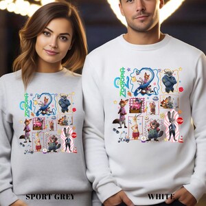Two people wearing white sweatshirts with colorful cartoon animal characters and various other cartoon-style elements printed on them.
