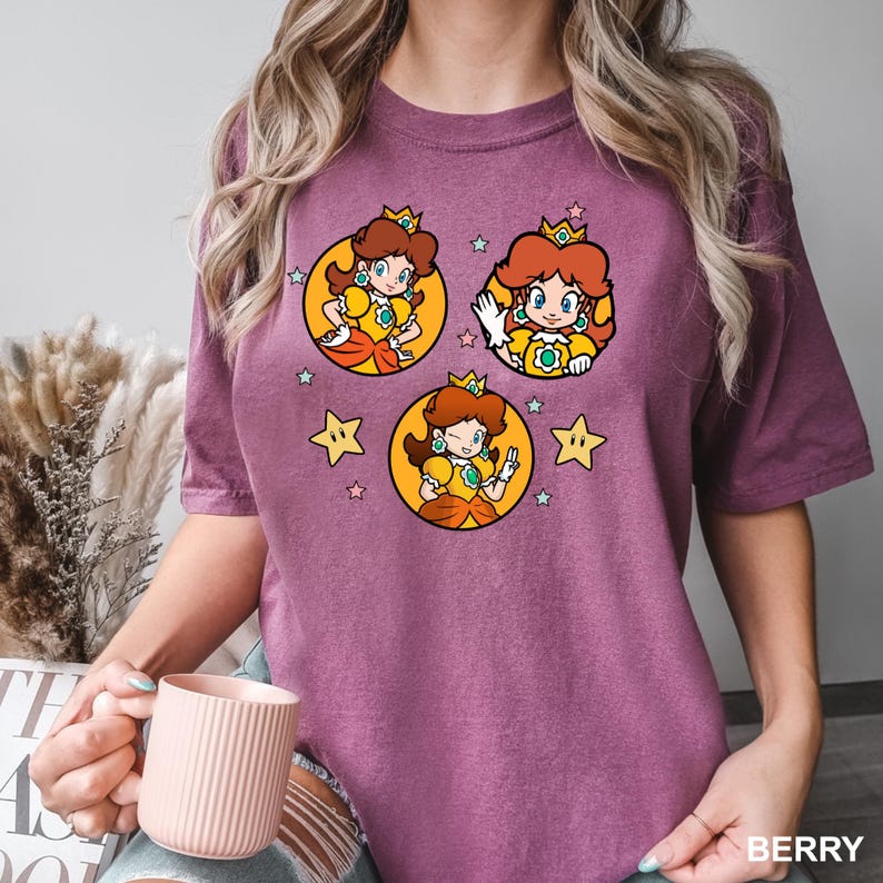 a woman is holding a cup and wearing a t - shirt