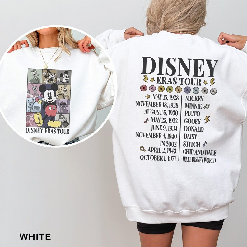 a woman wearing a white disney sweatshirt with a picture of mickey mouse on it