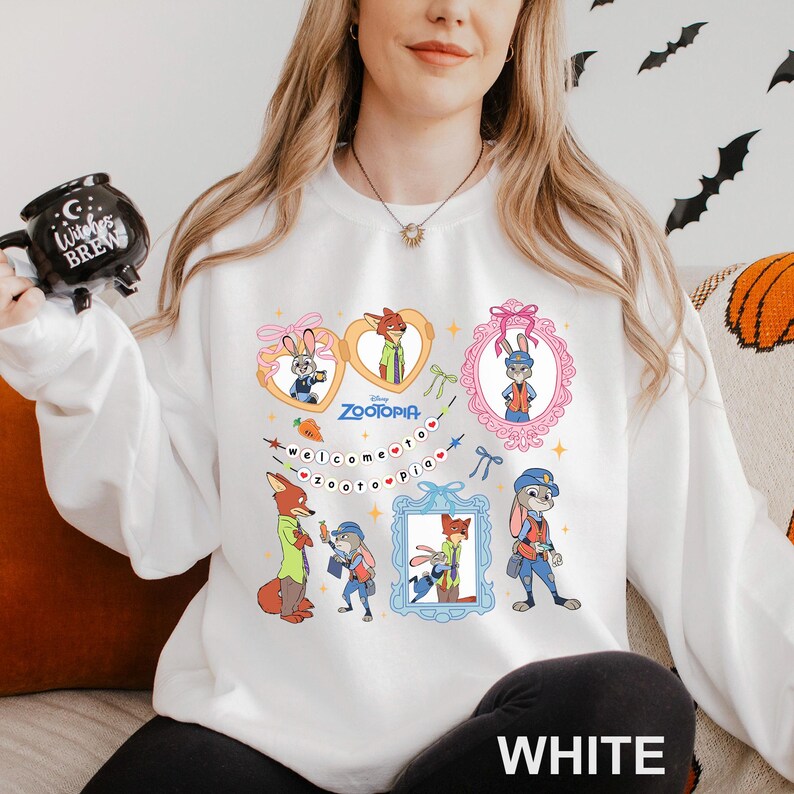 A woman wearing a white sweatshirt with a colorful graphic of cartoon characters from the movie "Zootopia" printed on it.