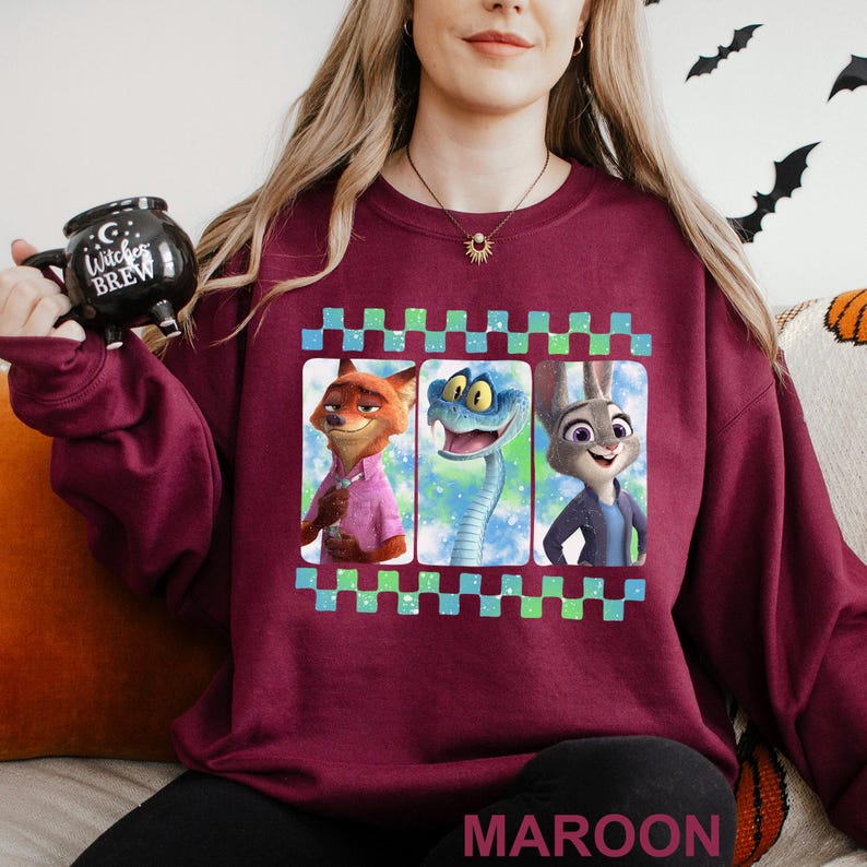A woman wearing a maroon sweater with a graphic design featuring cartoon animal characters.