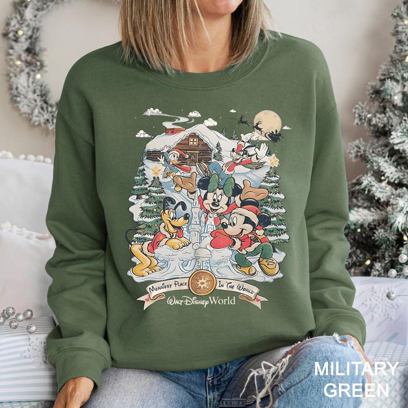 a woman sitting on a couch wearing a green sweatshirt