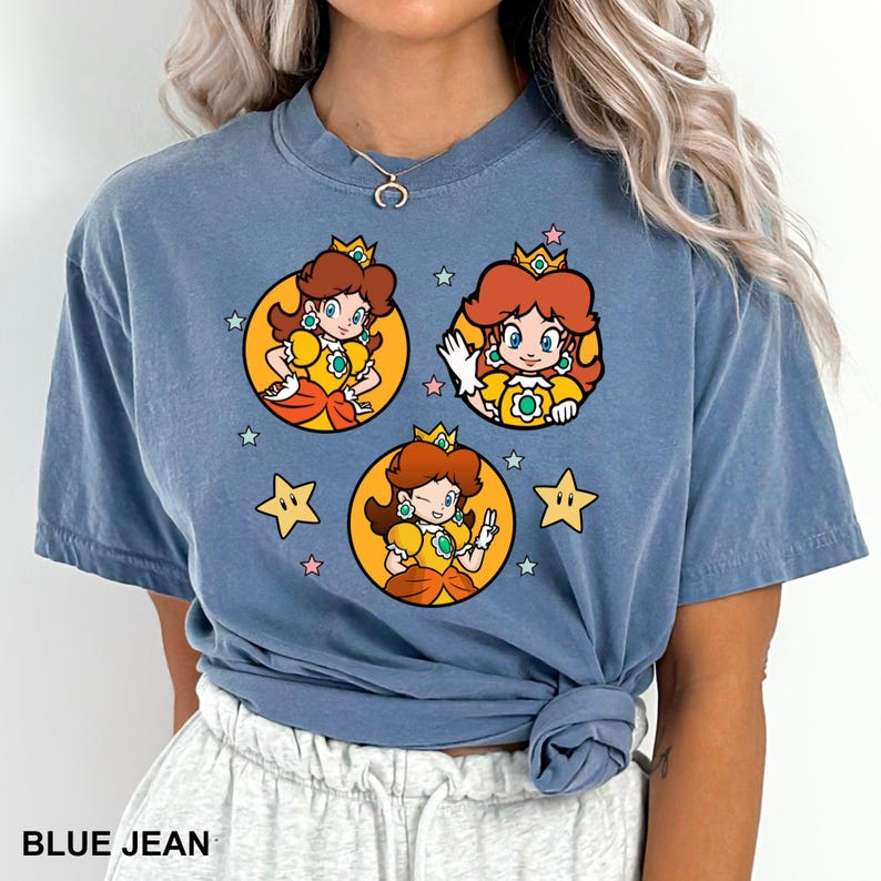 a woman wearing a blue tshirt with cartoon characters on it