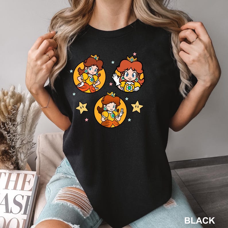 a woman wearing a black tshirt with cartoon characters on it