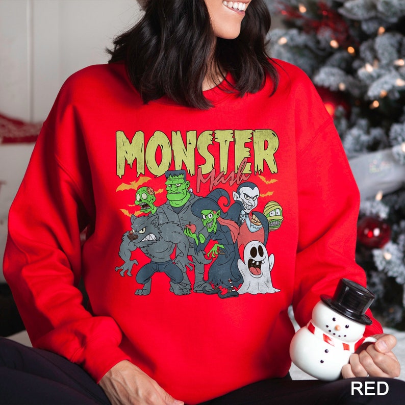 a woman in a red monster sweatshirt holding a snowman