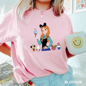 a woman in a pink shirt holding a cup of coffee