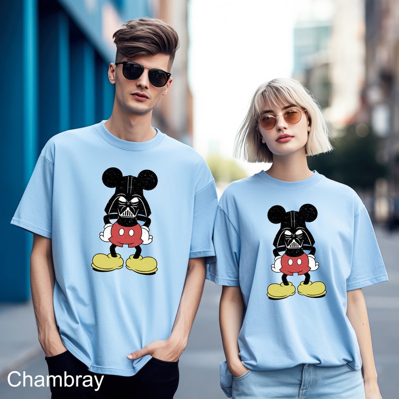 a man and a woman wearing mickey mouse shirts