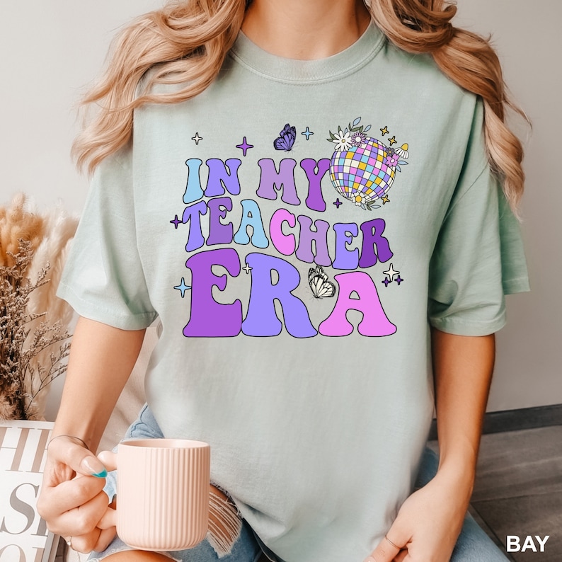 a woman holding a coffee cup and wearing a tshirt