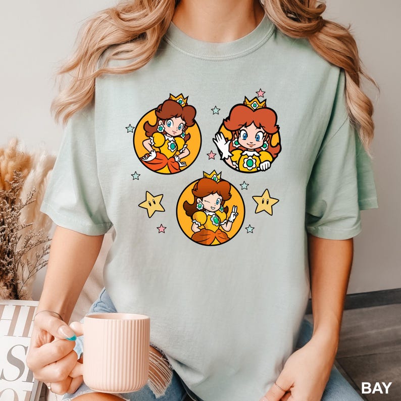 a woman is holding a coffee cup and wearing a t - shirt