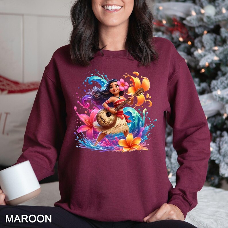 a woman sitting on a bed wearing a maroon sweatshirt