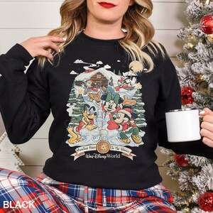 a woman wearing a mickey mouse christmas sweater