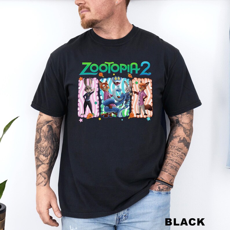 A man wearing a black t-shirt with a colorful graphic of cartoon characters from the movie Zootopia.