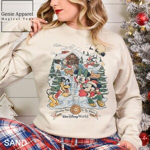 a woman wearing a mickey mouse christmas sweater