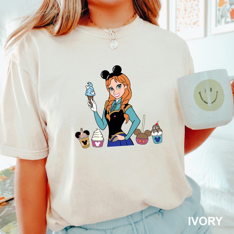 a woman is holding a cupcake and mickey mouse t - shirt Disney Queen Anna of Arendelle Shirt, Comfort Colors Disney Shirt, Disney Family Shirt, Disney Frozen Shirt, Disney Vacation Shirt