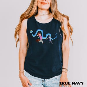 A woman wearing a navy blue tank top with a cartoon character design on it.