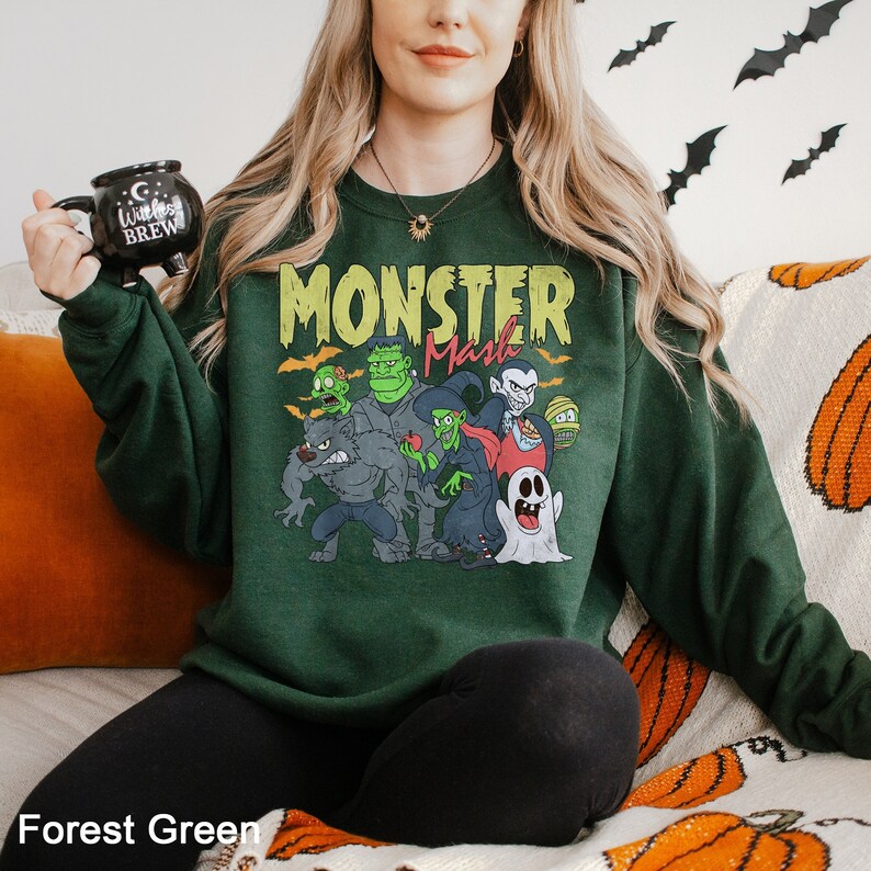 a woman sitting on a couch wearing a green monster sweatshirt