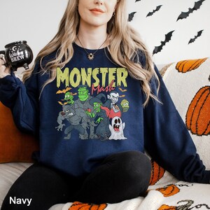 a woman sitting on a couch holding a remote