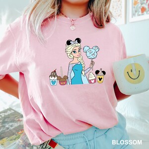 a woman in a pink shirt holding a cup of coffee